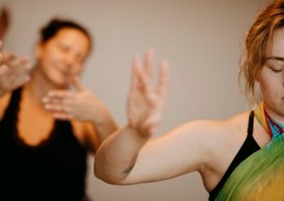 Two women learning the frigate step during a lomi lomi massage course