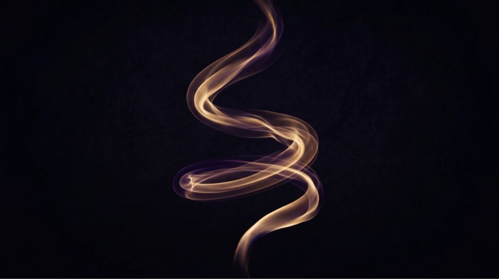 Symboliczne ujęcie energii w ruchu, spirala światła lub dymu na ciemnym tle, estetyka medytacyjna